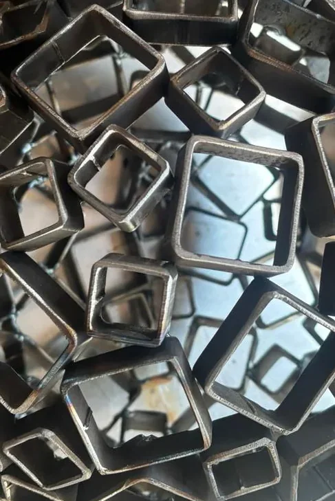 Close detail of the interconnected welded squares, each unique in size and angle.