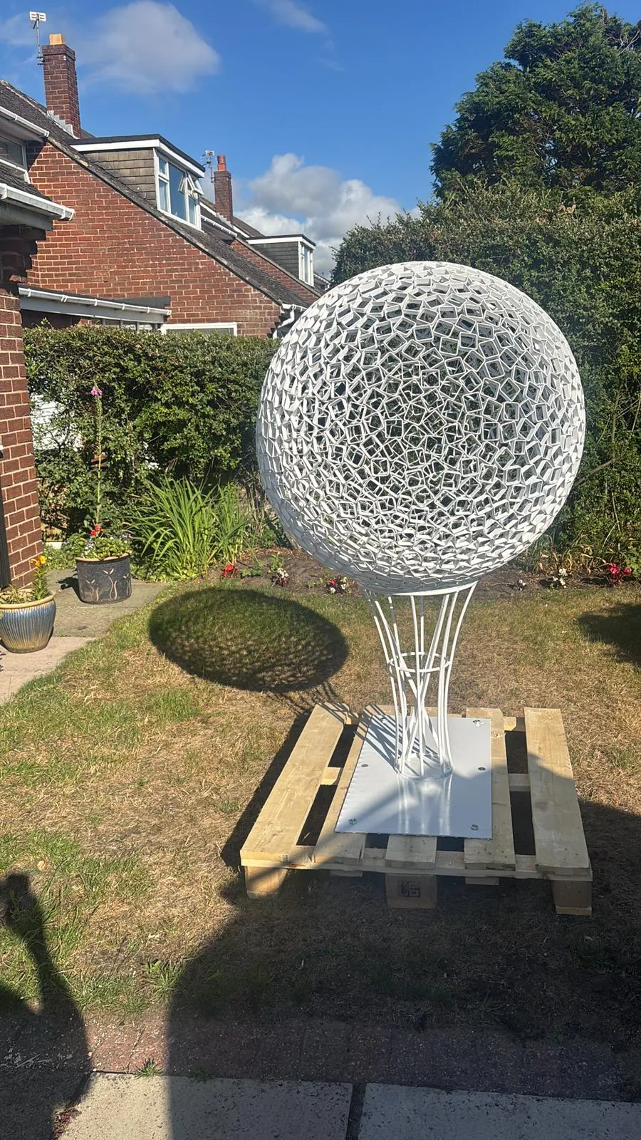 The finished white sculpture in the garden.